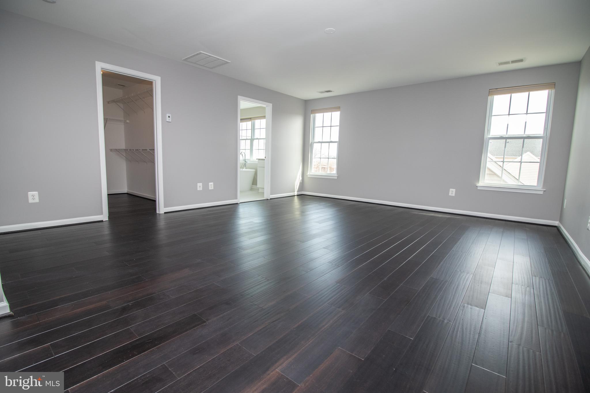 25257 Doolittle Lane Chantilly, VA 20152 - Photo 32 of 52 an empty room with wooden floor and windows