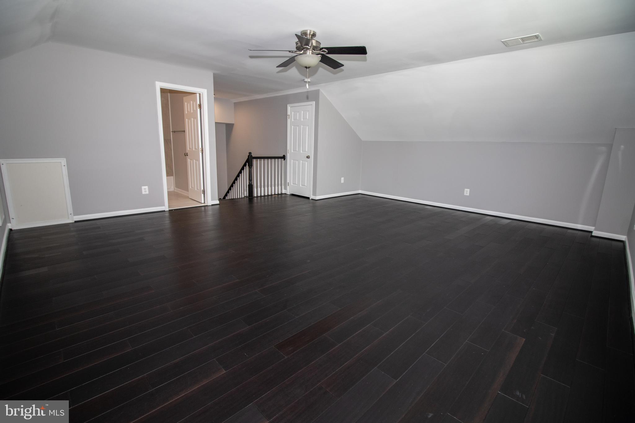 25257 Doolittle Lane Chantilly, VA 20152 - Photo 42 of 52 a view of a room with wooden floor and a ceiling fan