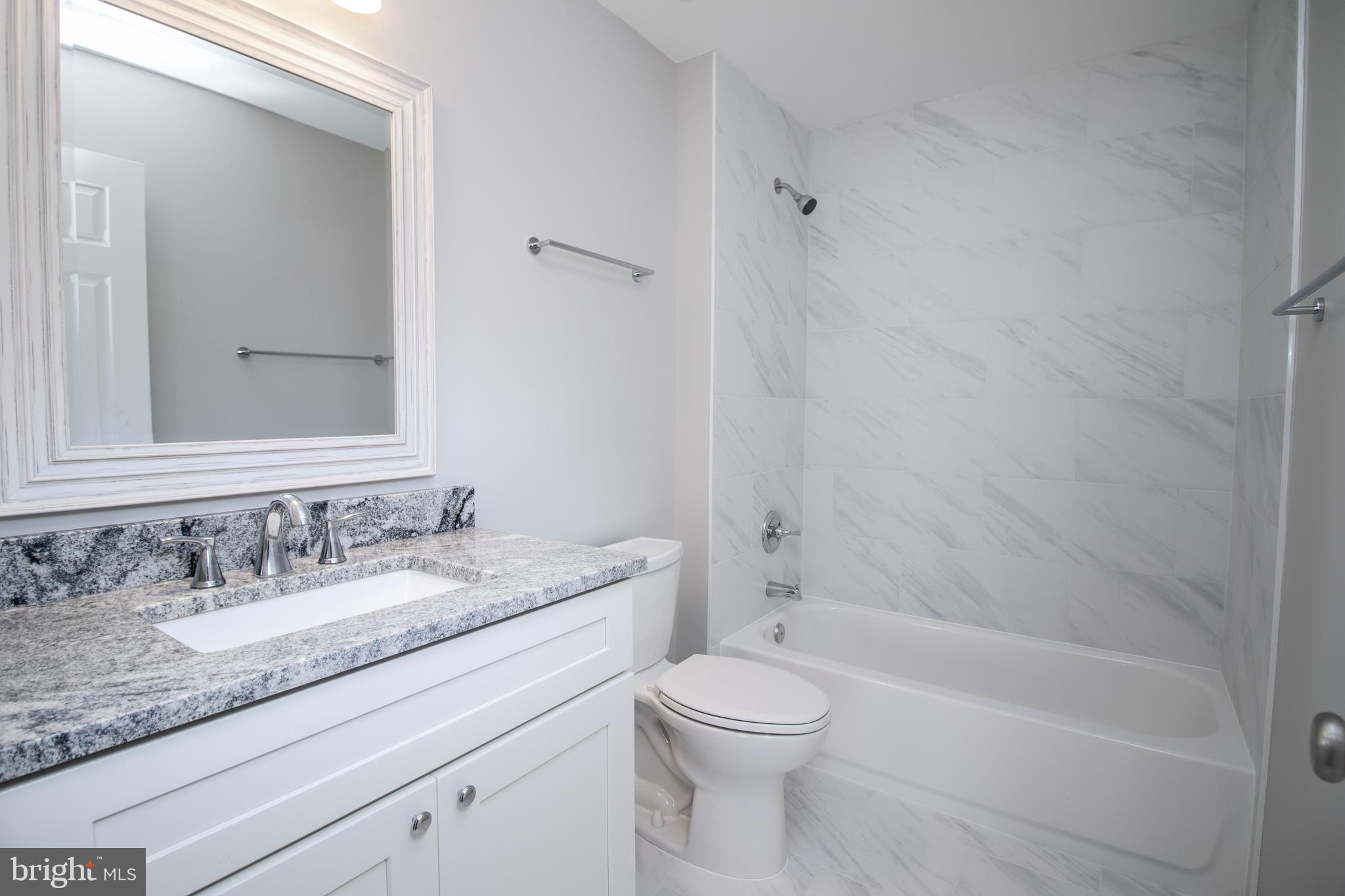 25257 Doolittle Lane Chantilly, VA 20152 - Photo 44 of 52 a bathroom with a granite countertop sink a toilet and shower