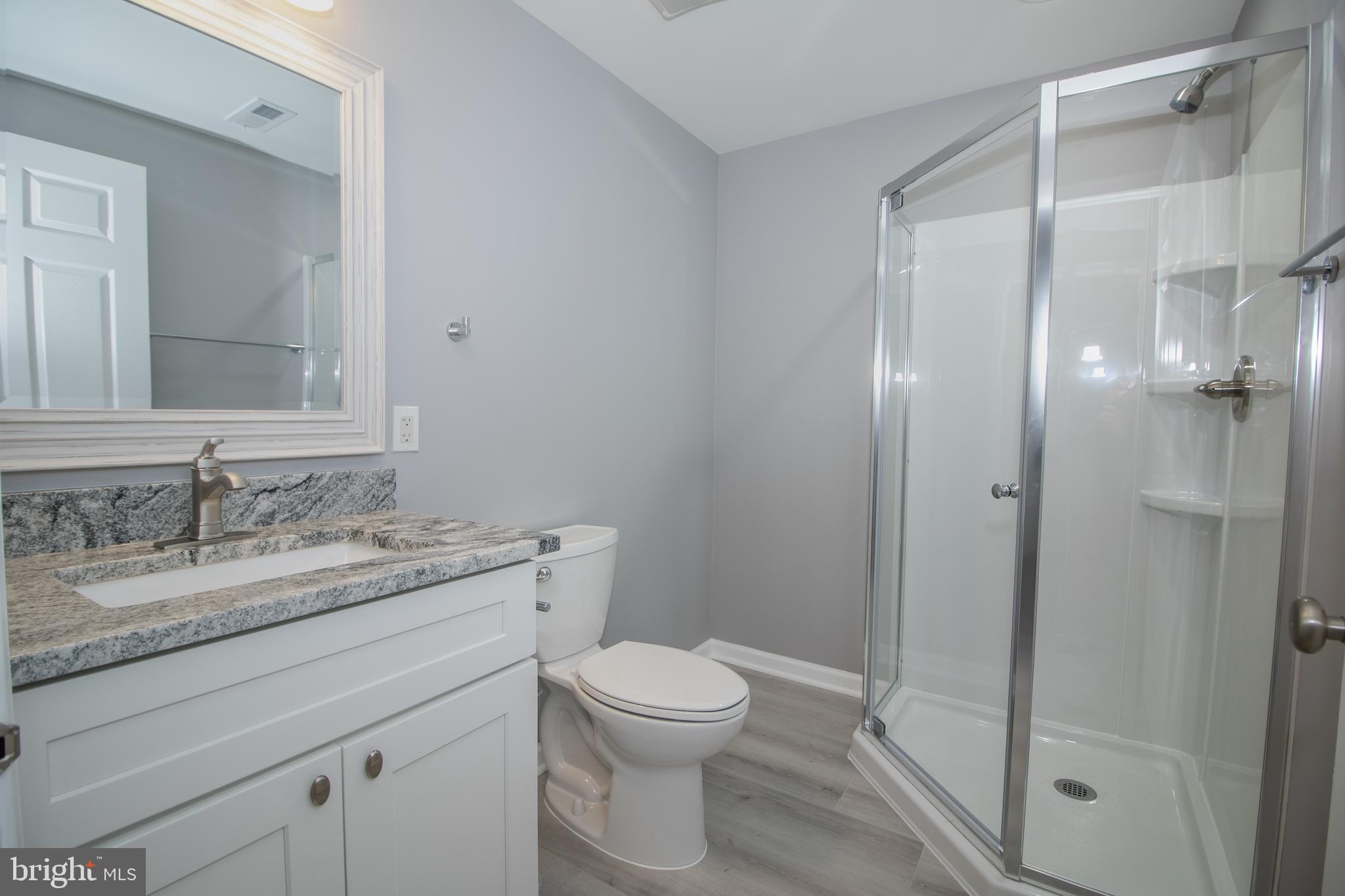 25257 Doolittle Lane Chantilly, VA 20152 - Photo 49 of 52 a bathroom with a granite countertop sink toilet a mirror and shower