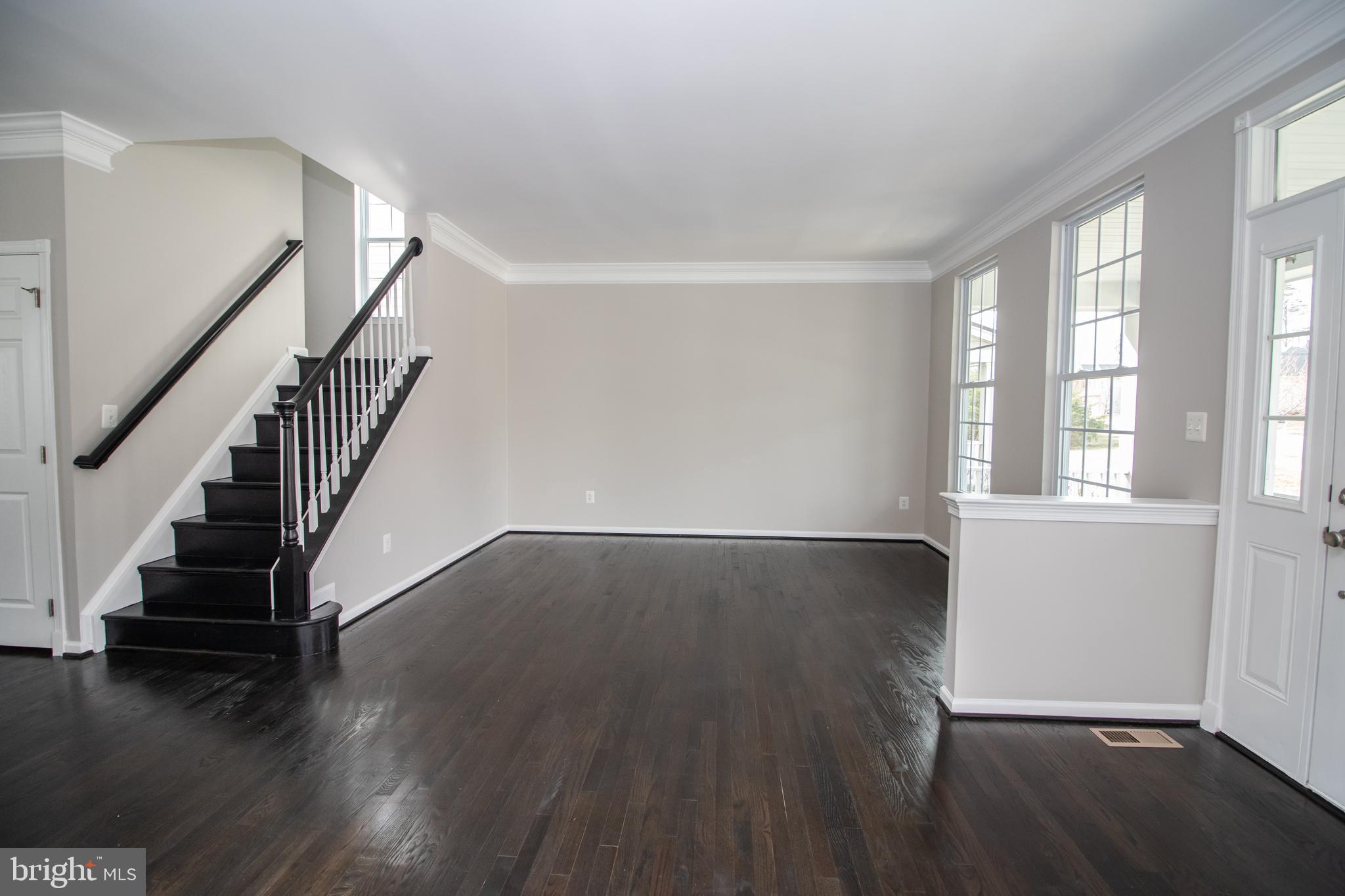 25257 Doolittle Lane Chantilly, VA 20152 - Photo 5 of 52 a view of an empty room with wooden floor and fan