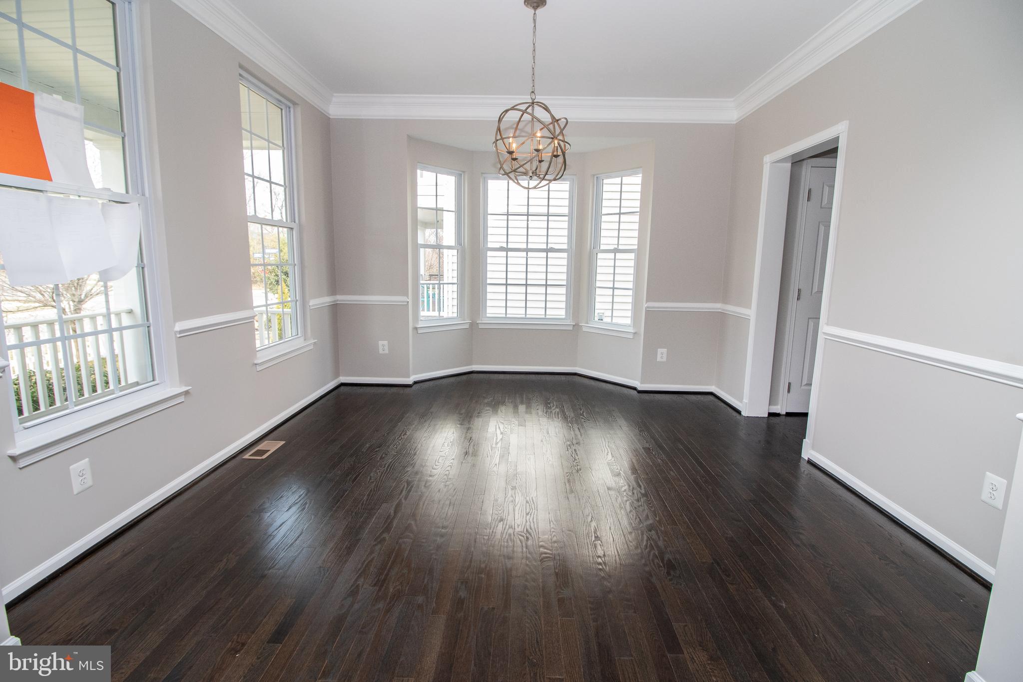 25257 Doolittle Lane Chantilly, VA 20152 - Photo 7 of 52 an empty room with wooden floor and windows