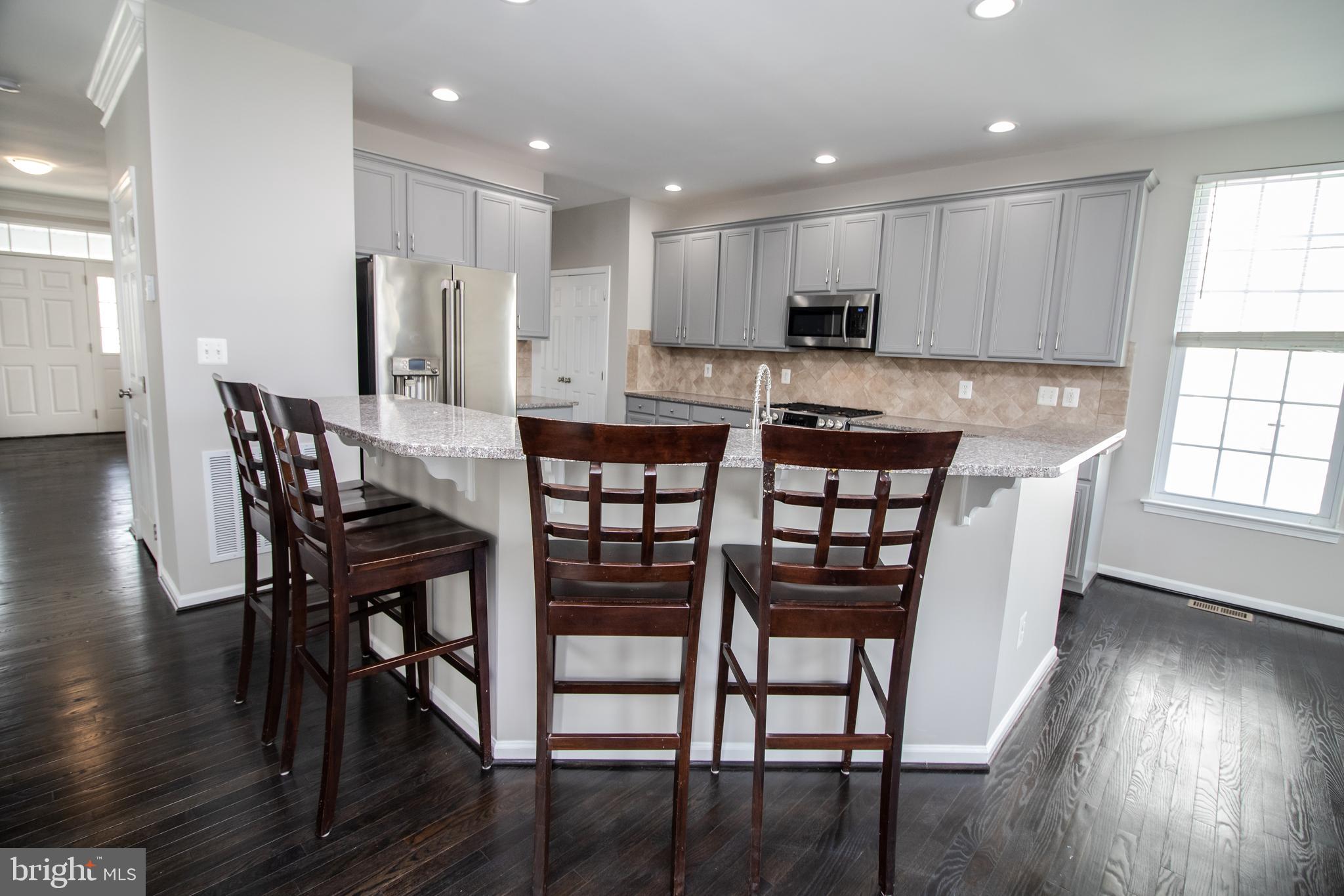 25257 Doolittle Lane Chantilly, VA 20152 - Photo 10 of 52 a view of a dining room with furniture and wooden floor