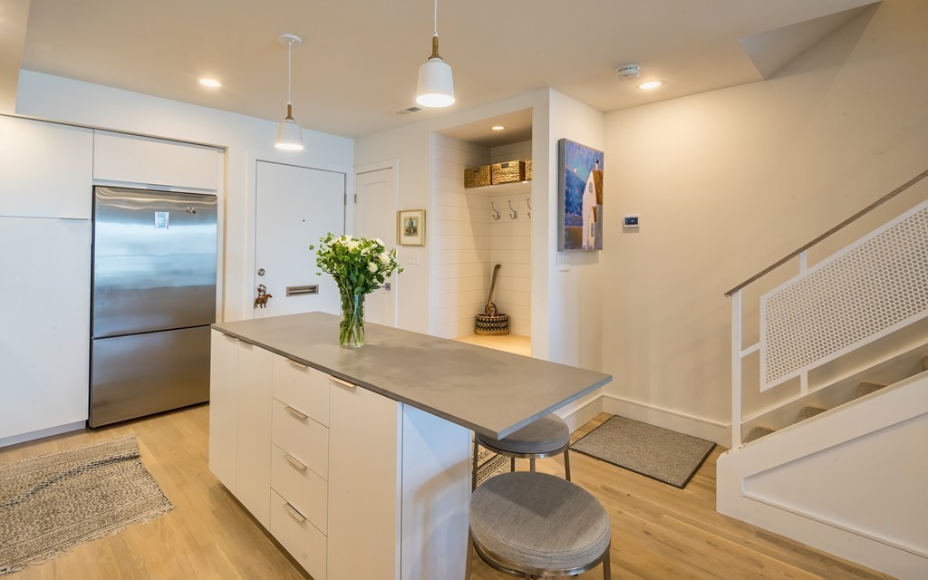 31 Constitution Way, Unit 31 Marblehead, MA 01945 - Photo 13 of 30 a kitchen with stainless steel appliances a table and chairs in it