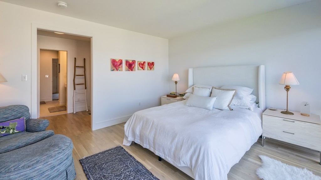 31 Constitution Way, Unit 31 Marblehead, MA 01945 - Photo 15 of 30 a bedroom with bed and wooden floor