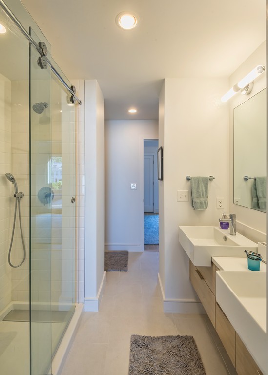 31 Constitution Way, Unit 31 Marblehead, MA 01945 - Photo 18 of 30 a spacious bathroom with a shower sink and mirror