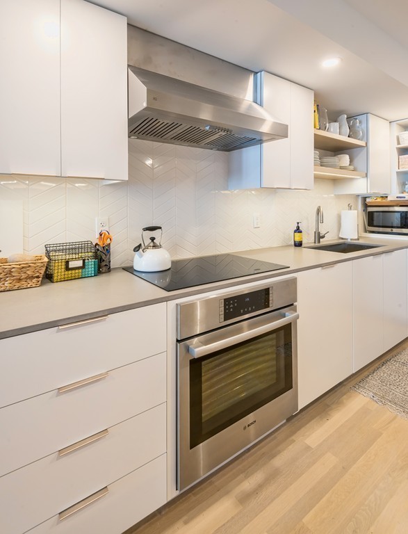 31 Constitution Way, Unit 31 Marblehead, MA 01945 - Photo 10 of 30 a kitchen with stainless steel appliances white cabinets and a stove top oven