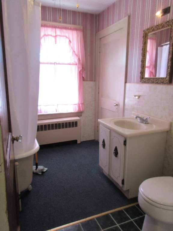 89 Columbus Avenue Greenfield, MA 01301 - Photo 12 of 20 a bathroom with a sink a toilet and a window