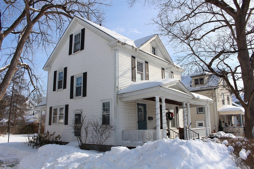 89 Columbus Avenue Greenfield, MA 01301 - Photo 18 of 20 a view of a white house with a large tree and windows