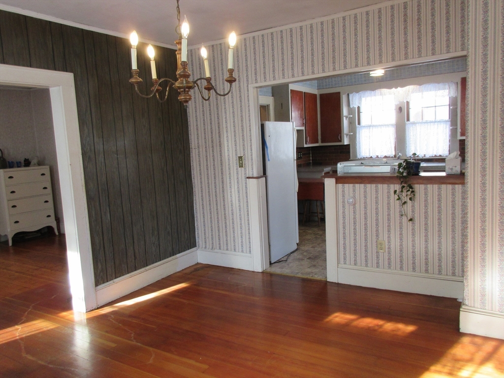 89 Columbus Avenue Greenfield, MA 01301 - Photo 8 of 20 a view of a livingroom with a kitchen space wooden floor and staircase