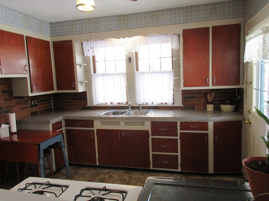 89 Columbus Avenue Greenfield, MA 01301 - Photo 9 of 20 a kitchen with stainless steel appliances granite countertop a sink stove and cabinets