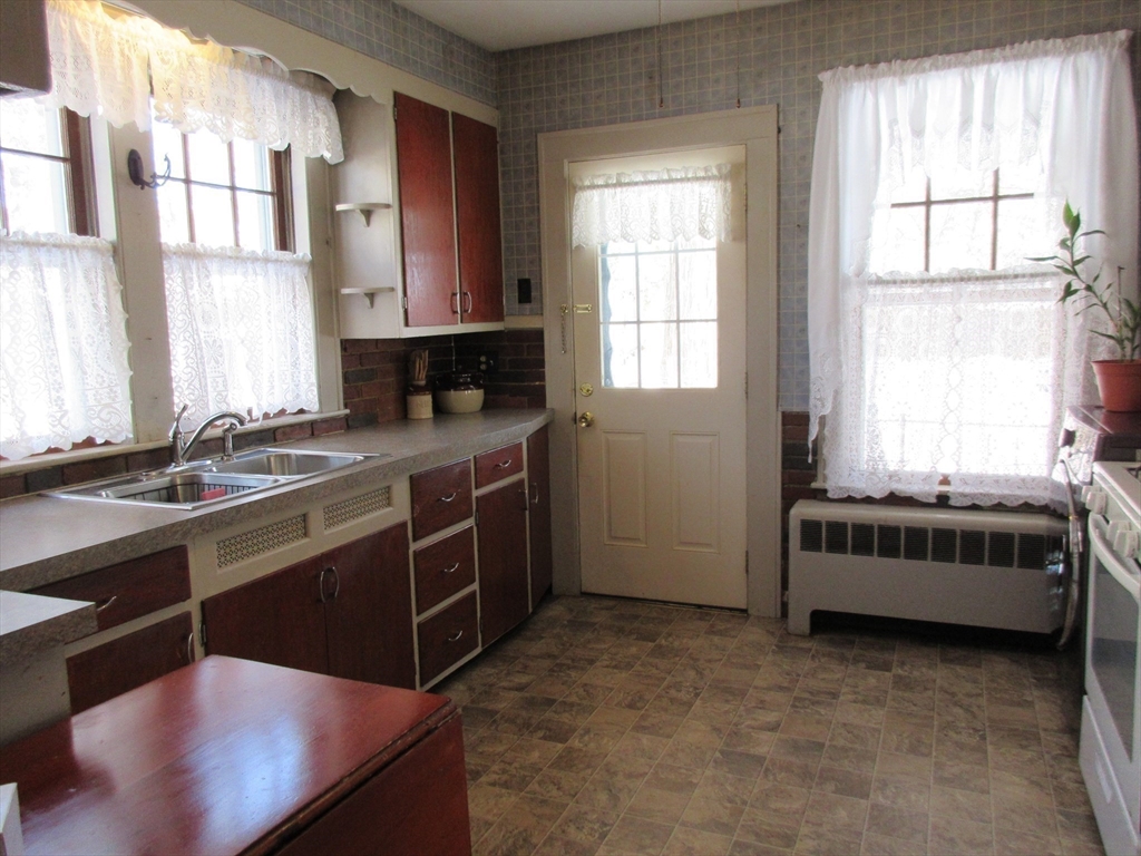 89 Columbus Avenue Greenfield, MA 01301 - Photo 10 of 20 a kitchen with a stove a sink and a window