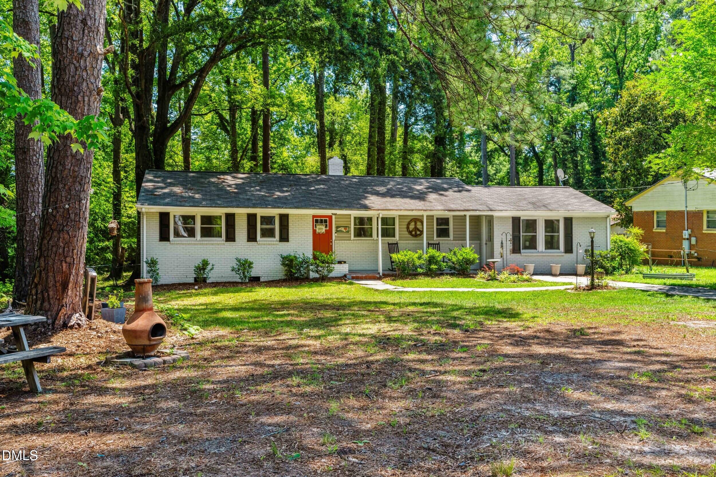 3724 Randell Road Garner, NC 27529 - Photo 5 of 32 a front view of a house with a yard table and chairs