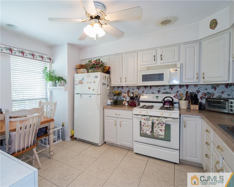 2403 Timber Oaks Road Edison, NJ 08820 - Photo 11 of 25 a kitchen with cabinets and window
