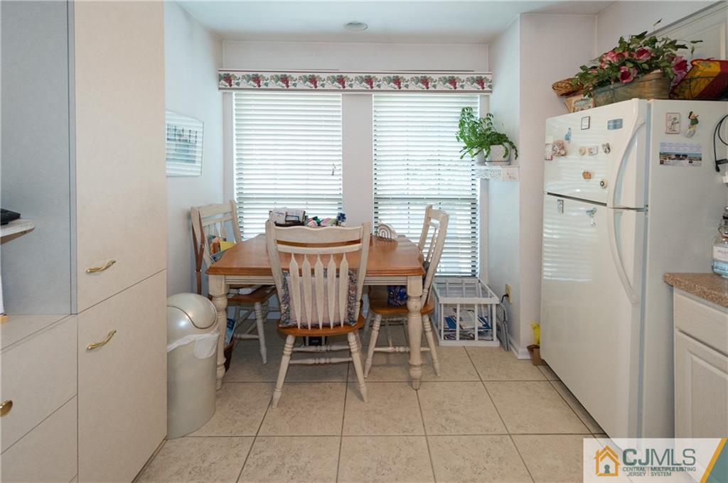 2403 Timber Oaks Road Edison, NJ 08820 - Photo 12 of 25 a dining room with furniture and window