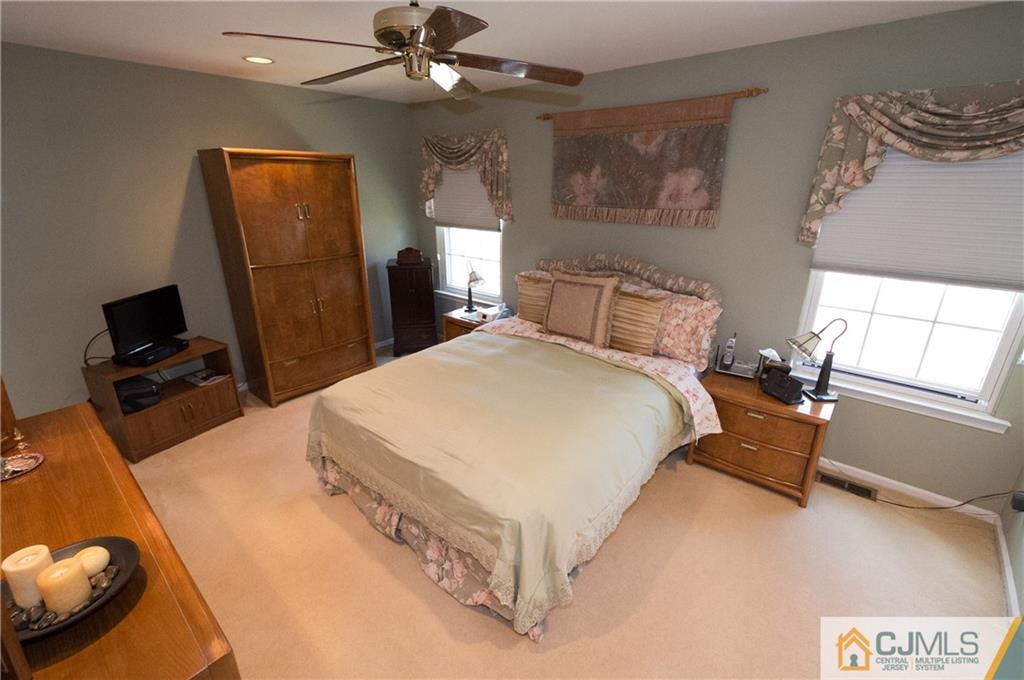 2403 Timber Oaks Road Edison, NJ 08820 - Photo 13 of 25 a bed room with a bed and a television