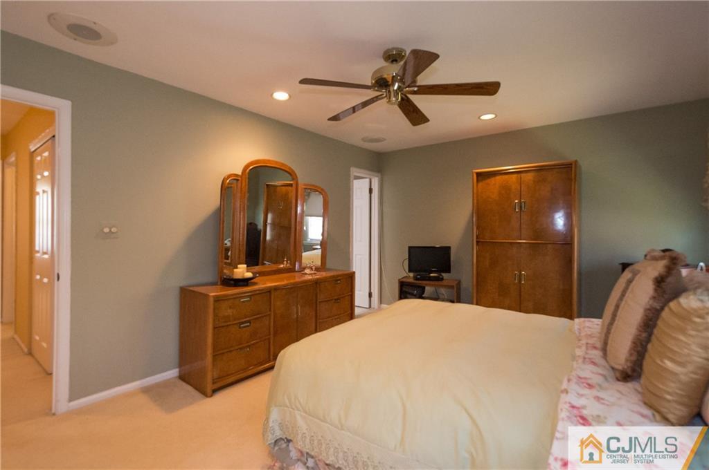 2403 Timber Oaks Road Edison, NJ 08820 - Photo 14 of 25 a bedroom with a bed and a dresser
