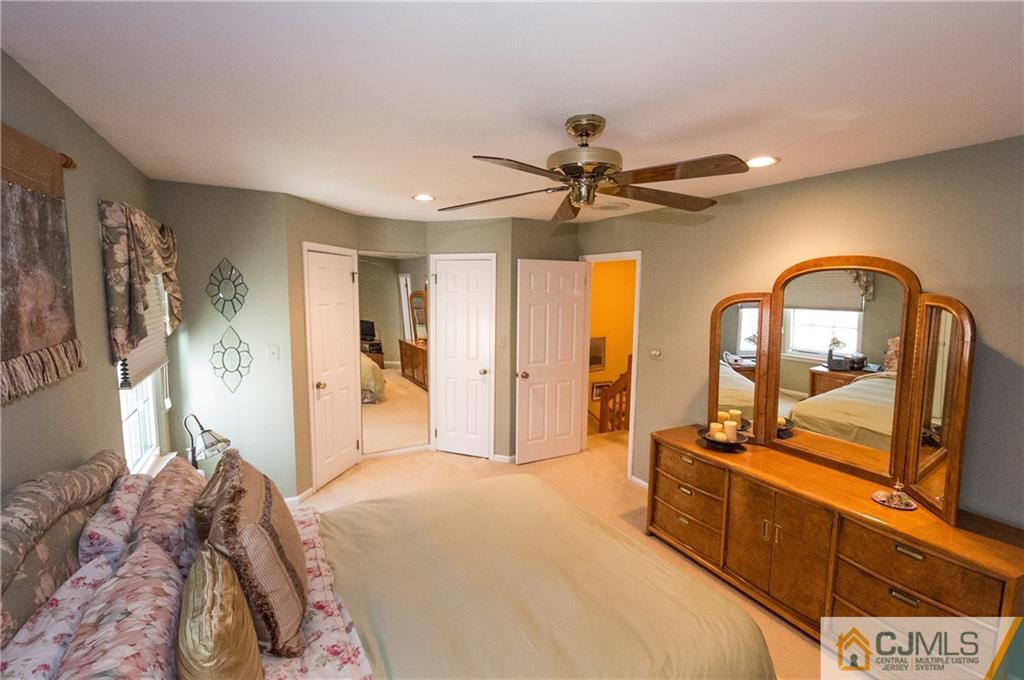 2403 Timber Oaks Road Edison, NJ 08820 - Photo 15 of 25 a bedroom with a large bed and ceiling fan