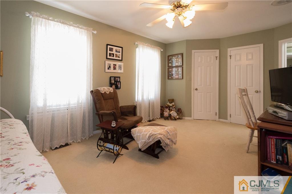 2403 Timber Oaks Road Edison, NJ 08820 - Photo 19 of 25 a bedroom with a bed and a flat screen tv