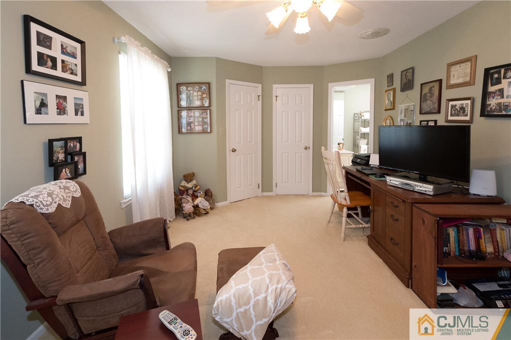 2403 Timber Oaks Road Edison, NJ 08820 - Photo 20 of 25 a living room with furniture and a flat screen tv