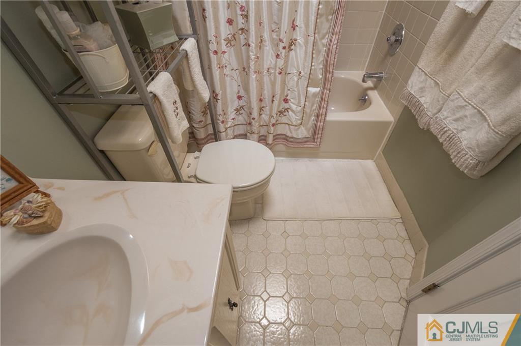 2403 Timber Oaks Road Edison, NJ 08820 - Photo 21 of 25 a bathroom with a sink and toilet