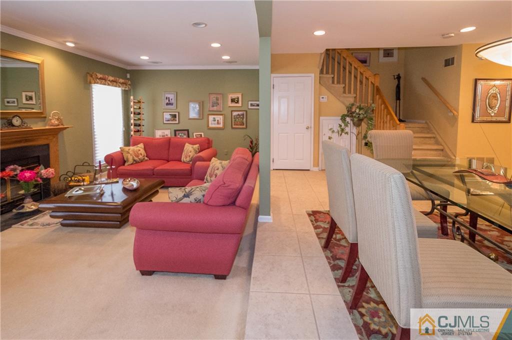 2403 Timber Oaks Road Edison, NJ 08820 - Photo 5 of 25 a living room with furniture a fireplace and a flat screen tv