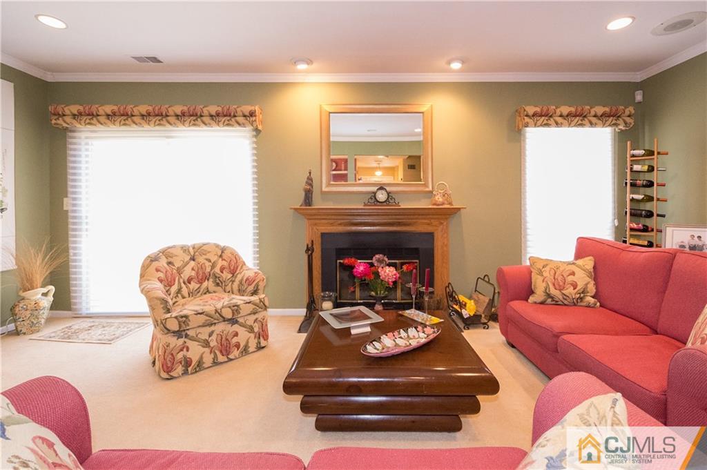 2403 Timber Oaks Road Edison, NJ 08820 - Photo 8 of 25 a living room with furniture and a fireplace