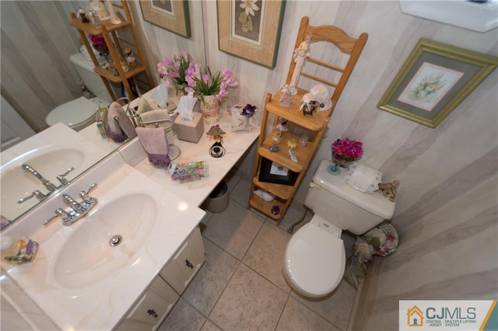 2403 Timber Oaks Road Edison, NJ 08820 - Photo 10 of 25 a bathroom with a sink mirror and toilet