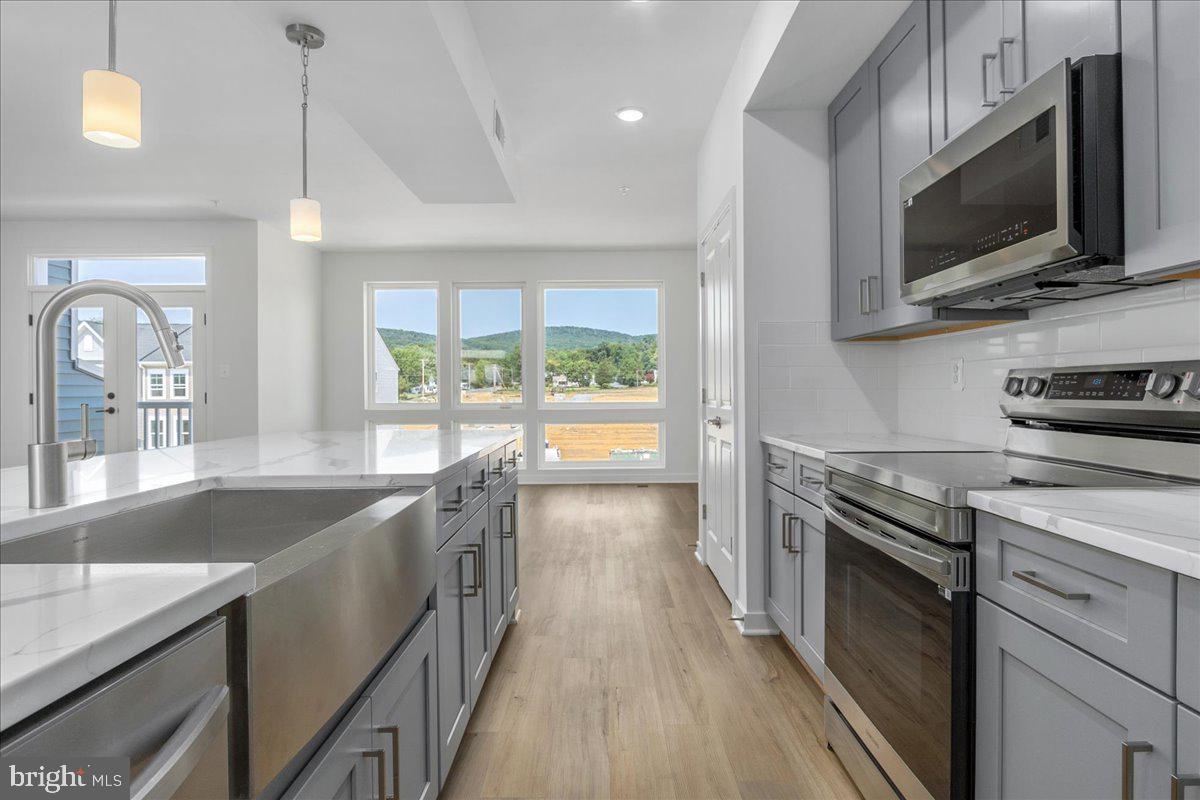 711 Iron Frg Road, Unit A Frederick, MD 21702 - Photo 1 of 18 a kitchen with a sink and steel appliances