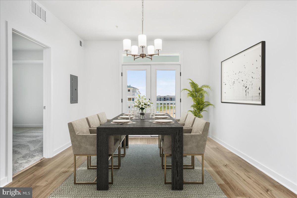 711 Iron Frg Road, Unit A Frederick, MD 21702 - Photo 10 of 18 a view of a dining room with furniture window and wooden floor