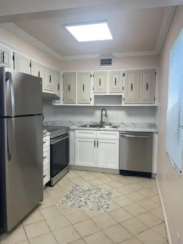 a kitchen with a stove top oven sink and refrigerator