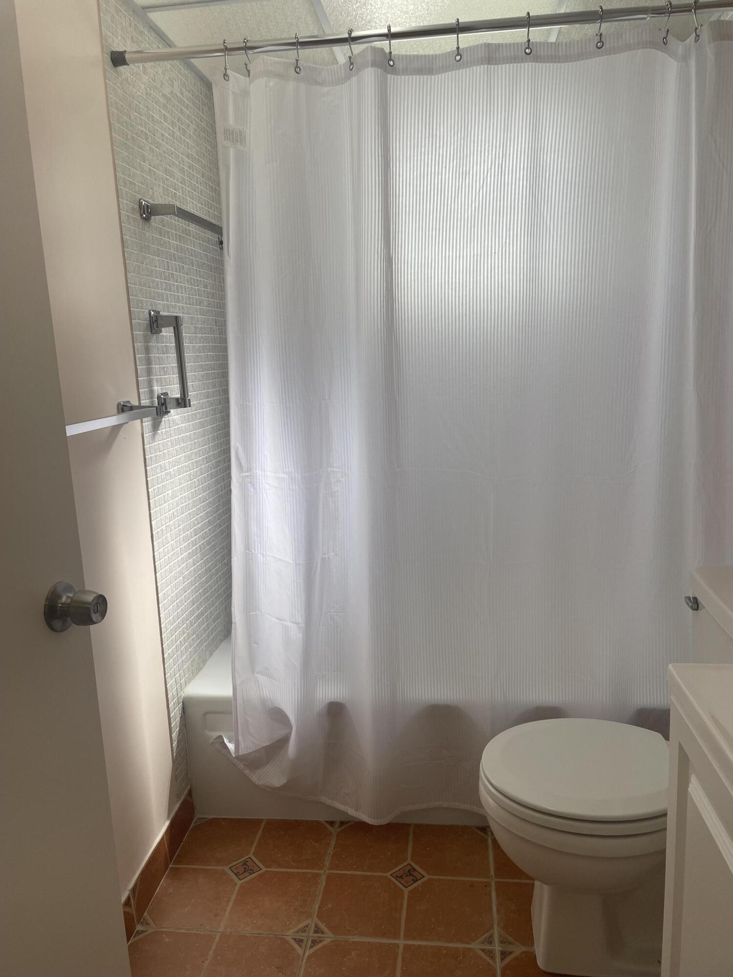 402 Monaco Way, Unit I Delray Beach, FL 33446 - Photo 12 of 25 a bathroom with a toilet and a shower