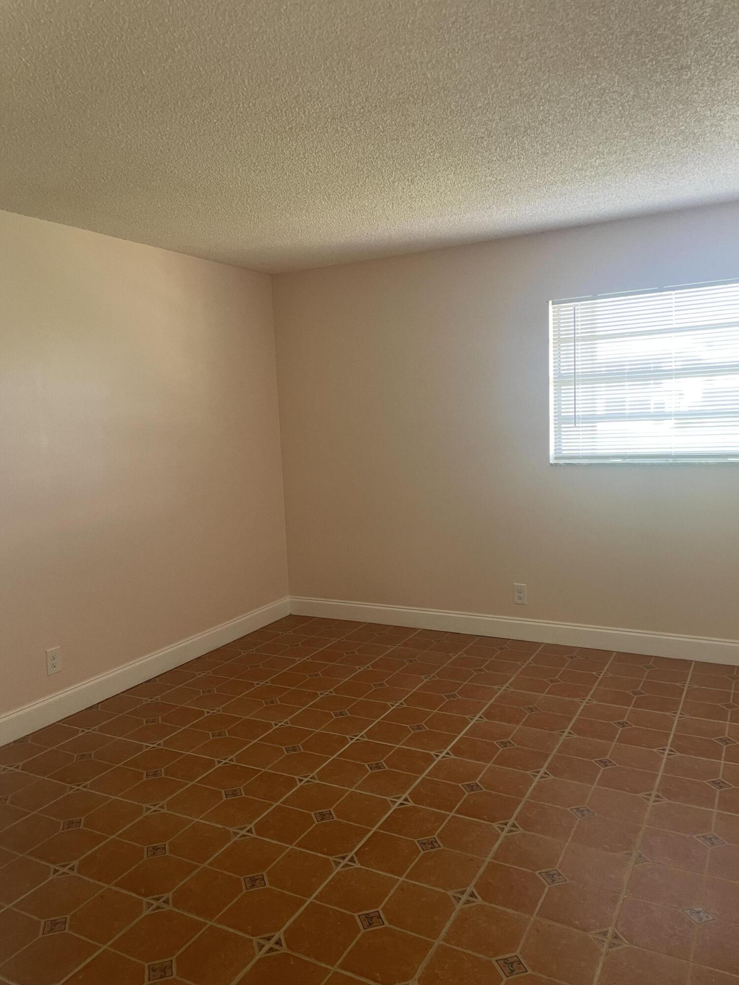 402 Monaco Way, Unit I Delray Beach, FL 33446 - Photo 13 of 25 a view of an empty room with a window