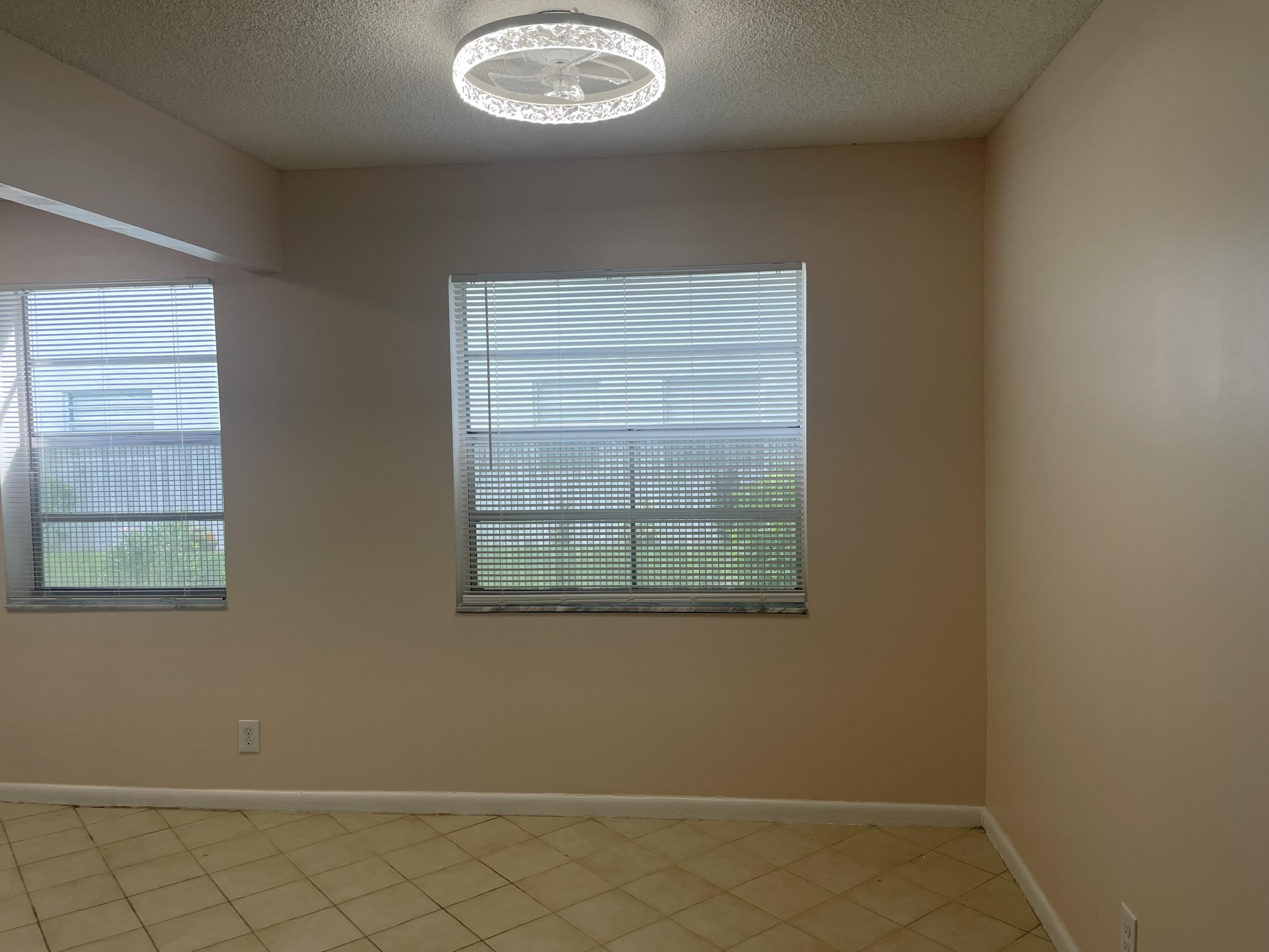 402 Monaco Way, Unit I Delray Beach, FL 33446 - Photo 7 of 25 an empty room with windows