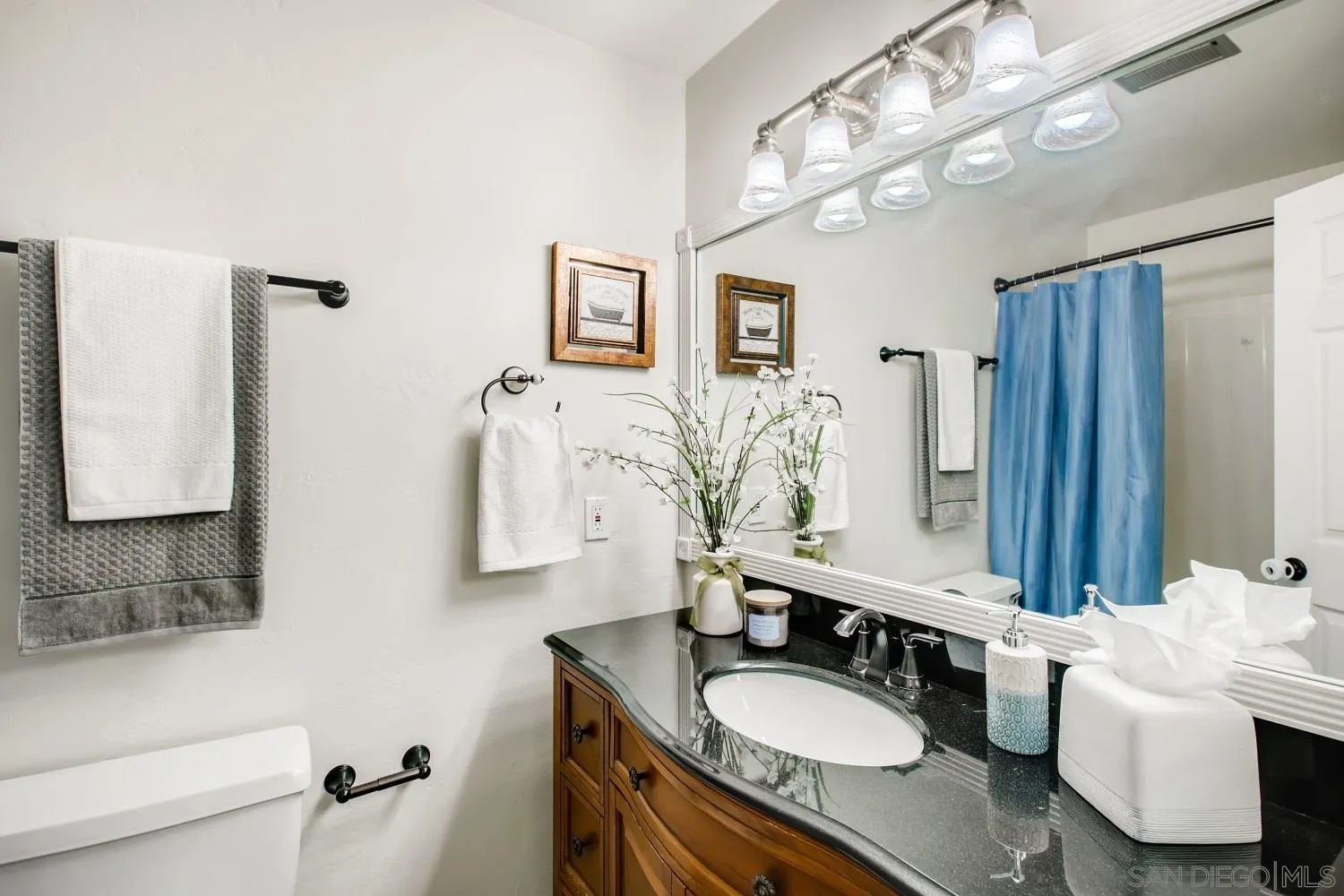 13639 Utopia Road Poway, CA 92064 - Photo 18 of 25 a bathroom with a granite countertop sink a mirror and a shower