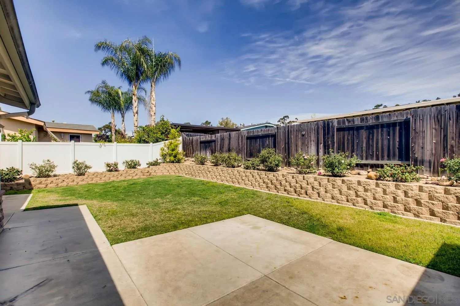 13639 Utopia Road Poway, CA 92064 - Photo 24 of 25 a view of a backyard with table and chairs potted plants and large tree