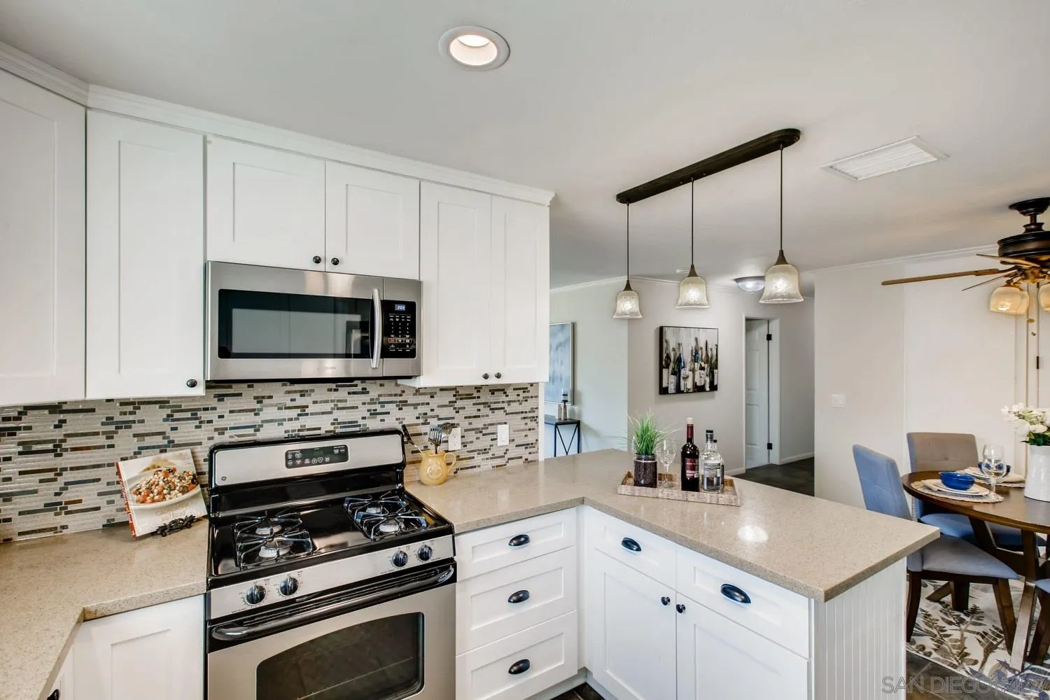 13639 Utopia Road Poway, CA 92064 - Photo 8 of 25 a kitchen with stainless steel appliances a stove sink and white cabinets