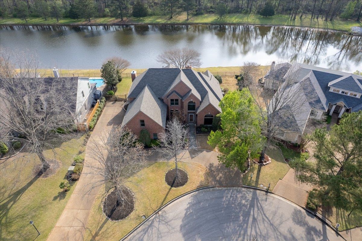 an aerial view of a house with a lake view
