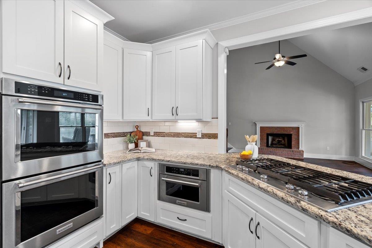 10440 Ansley Cove Collierville, TN 38017 - Photo 16 of 40 a kitchen with granite countertop a stove and a microwave