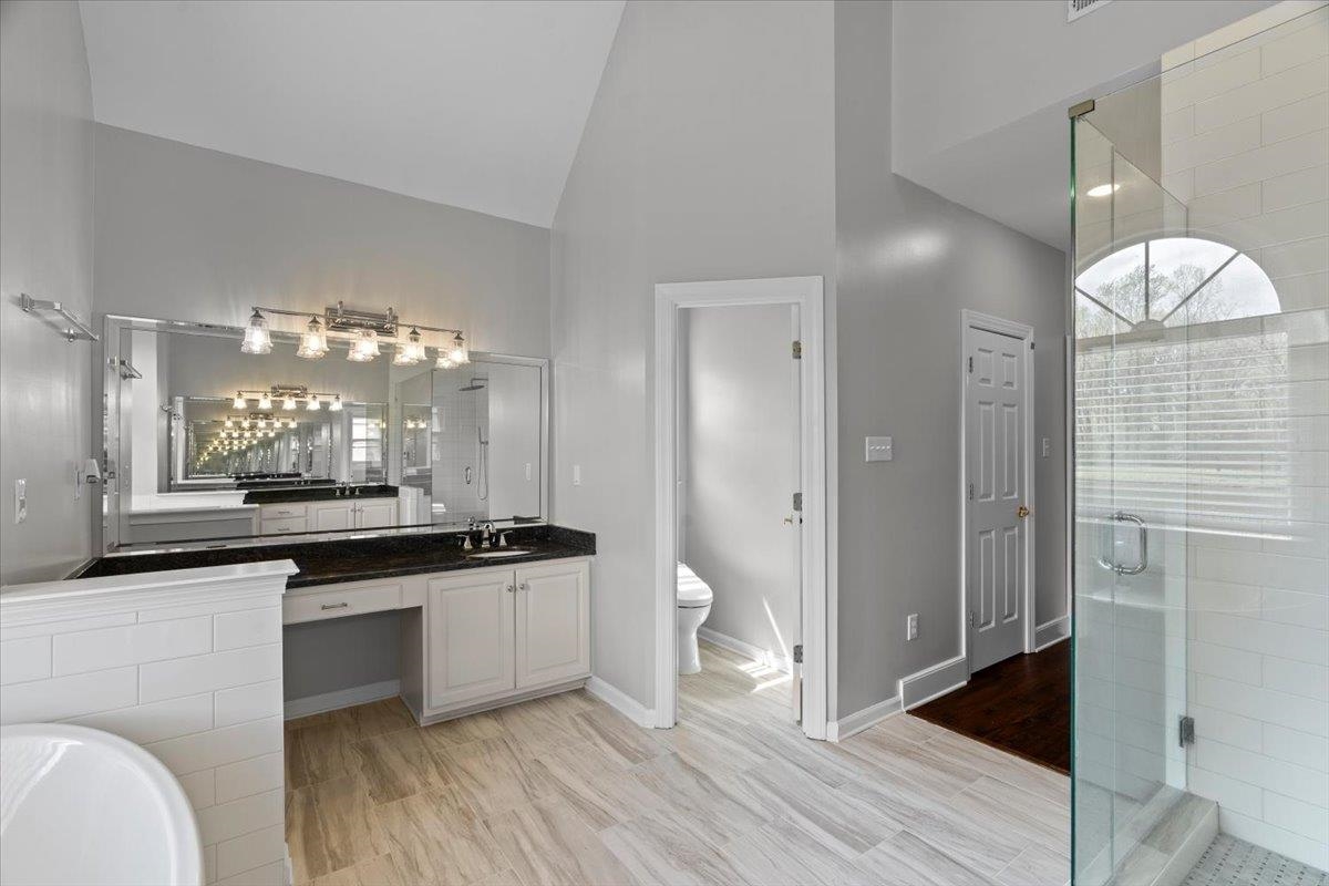 10440 Ansley Cove Collierville, TN 38017 - Photo 23 of 40 a kitchen with granite countertop a sink and cabinets