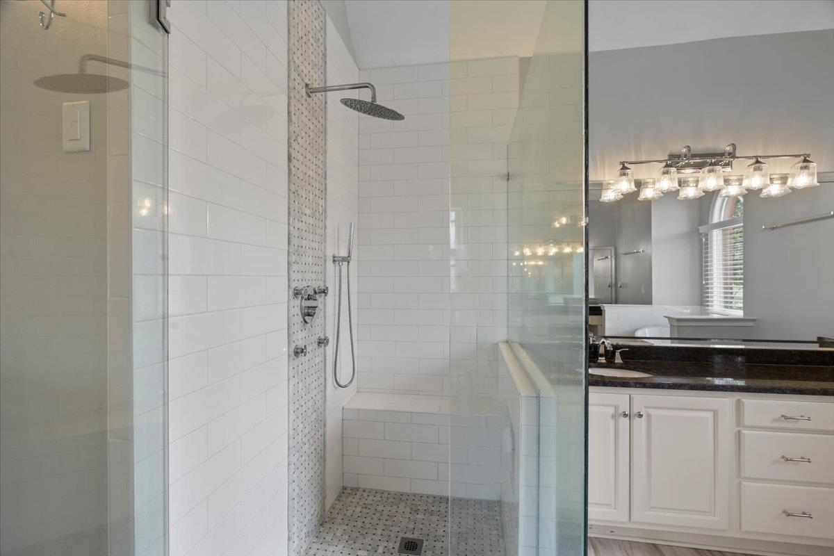 10440 Ansley Cove Collierville, TN 38017 - Photo 24 of 40 a bathroom with a granite countertop shower a mirror and a sink