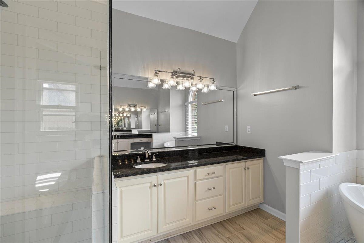10440 Ansley Cove Collierville, TN 38017 - Photo 25 of 40 a bathroom with a granite countertop sink a large mirror and a shower