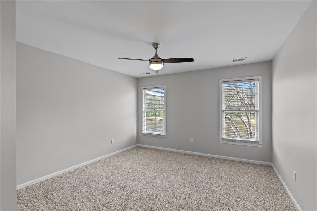 10440 Ansley Cove Collierville, TN 38017 - Photo 29 of 40 an empty room with windows and ceiling fan