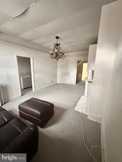 a bedroom with furniture and a chandelier