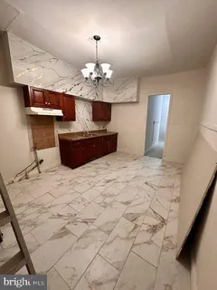 a view of a kitchen with marble kitchen and chandelier