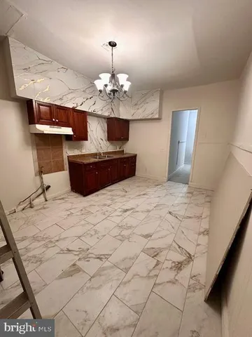a view of a kitchen with marble kitchen and chandelier