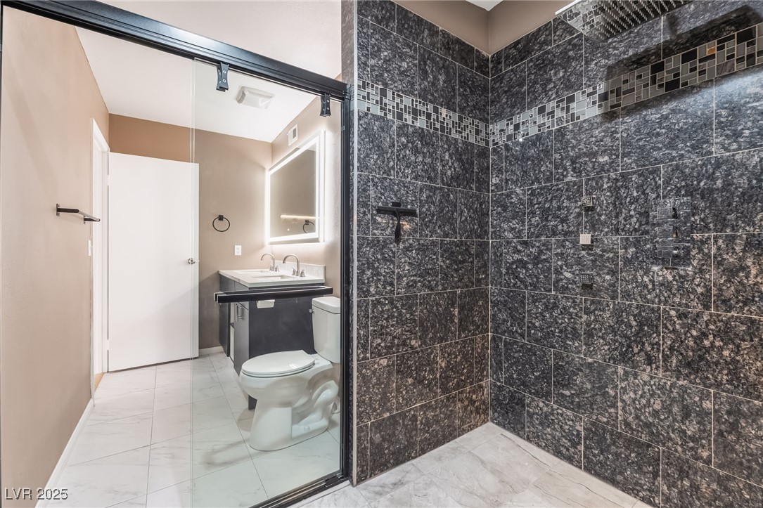 2246 East Russell Road Las Vegas, NV 89119 - Photo 13 of 24 Bathroom featuring vanity and light marble finish floors
