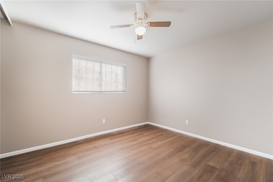 2246 East Russell Road Las Vegas, NV 89119 - Photo 14 of 24 Spare room with wood finished floors and a ceiling fan