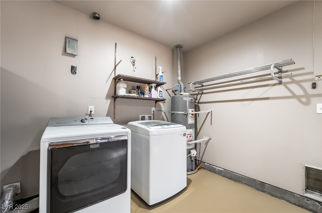 2246 East Russell Road Las Vegas, NV 89119 - Photo 19 of 24 Laundry room featuring strapped water heater and washer and clothes dryer