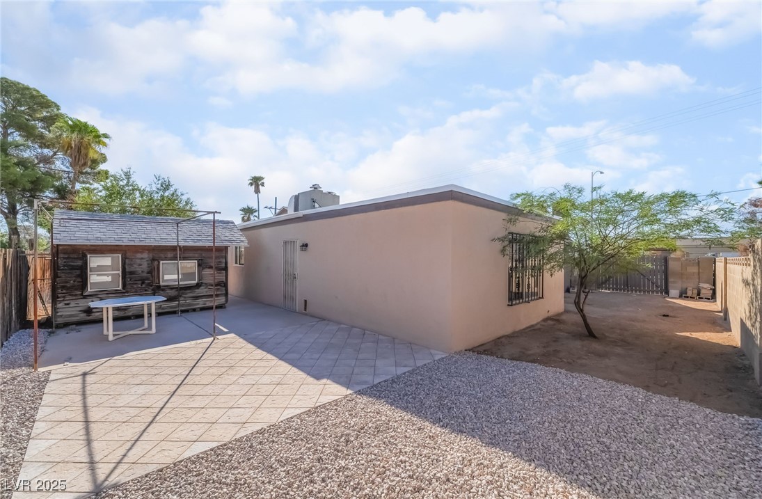 2246 East Russell Road Las Vegas, NV 89119 - Photo 20 of 24 Back of property with stucco siding, a patio area, and stone siding